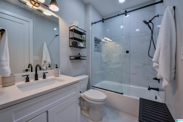 full bathroom featuring toilet, shower / bath combination with glass door, and vanity