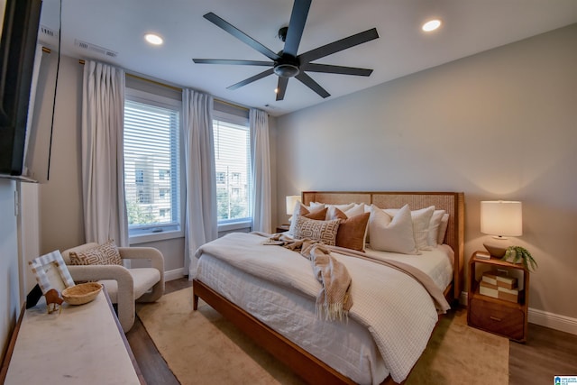 bedroom with recessed lighting, visible vents, ceiling fan, wood finished floors, and baseboards