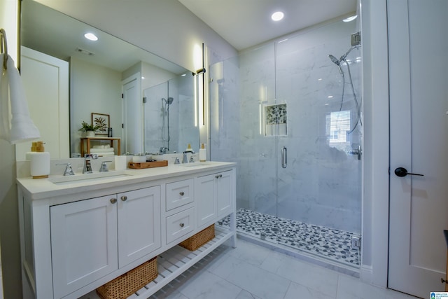 full bathroom featuring double vanity, marble finish floor, visible vents, and a sink