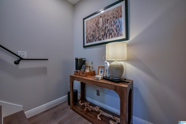 interior space featuring baseboards and dark wood-style flooring