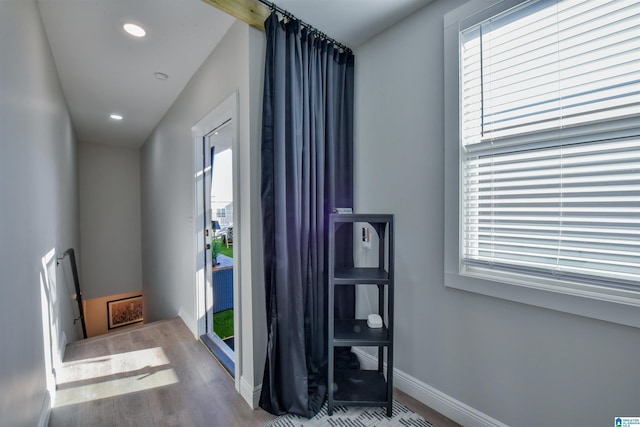 interior space featuring baseboards, wood finished floors, and recessed lighting