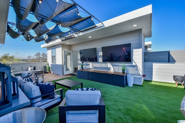 back of house featuring a lawn and outdoor lounge area