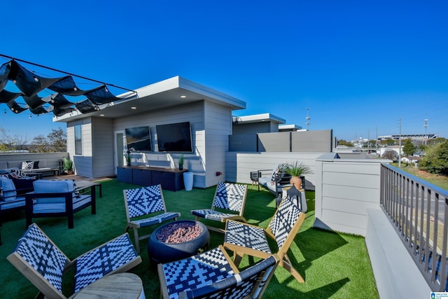 exterior space featuring a yard and an outdoor living space with a fire pit