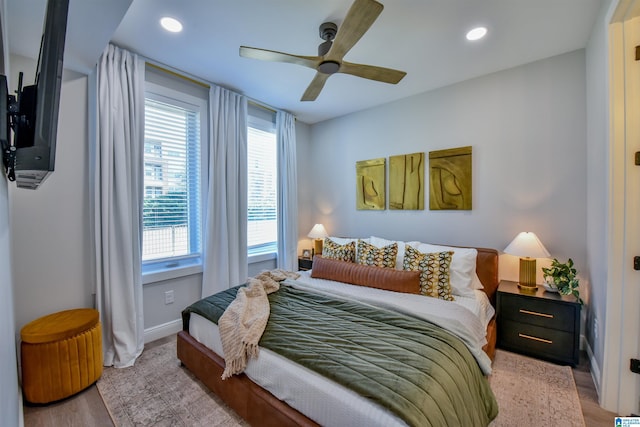 bedroom with baseboards, light wood finished floors, a ceiling fan, and recessed lighting