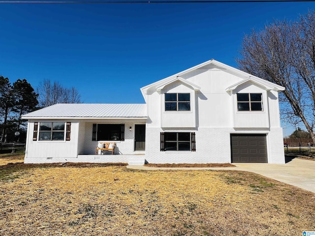 view of front facade featuring brick siding, concrete driveway, crawl space, metal roof, and a garage