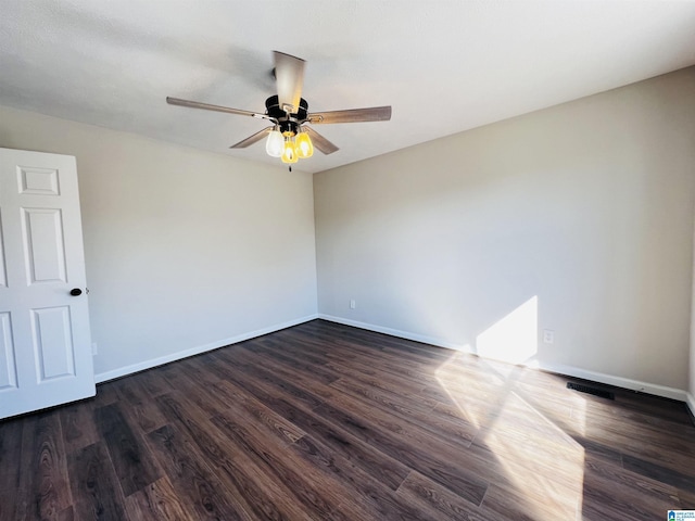 unfurnished room featuring a ceiling fan, baseboards, and dark wood-type flooring