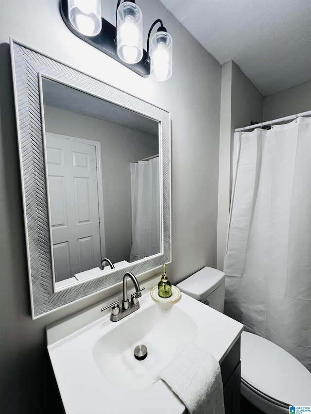 full bathroom featuring toilet and vanity