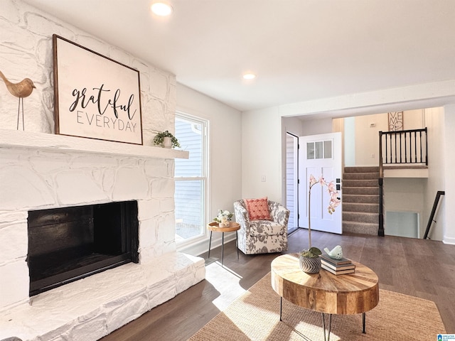 living area with stairs, a fireplace, wood finished floors, and recessed lighting