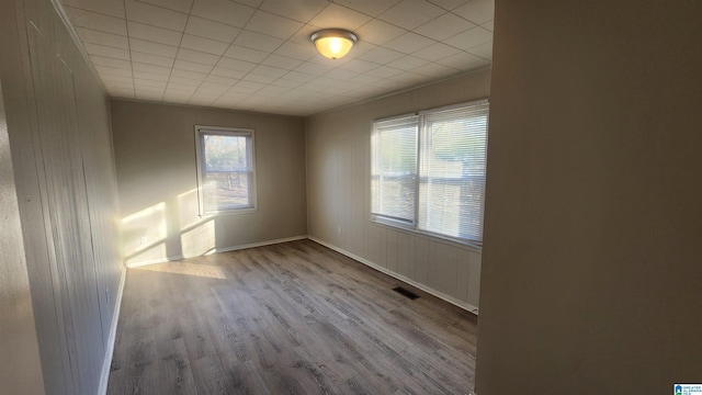 spare room with light wood finished floors and baseboards