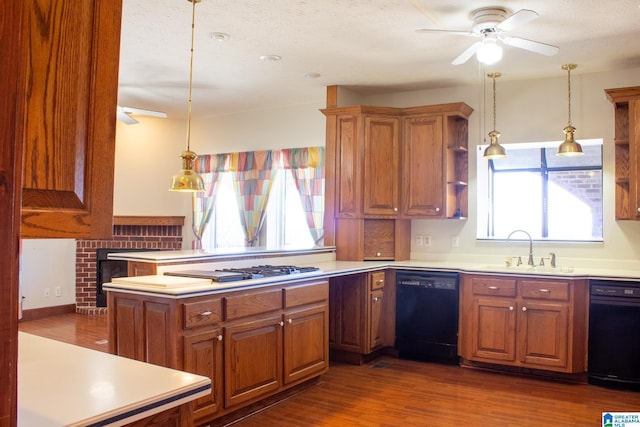 kitchen with dishwasher, hanging light fixtures, a sink, and light countertops