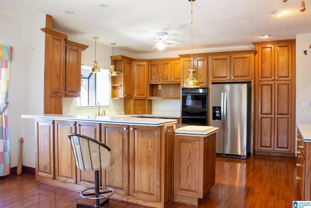 kitchen with brown cabinets, hanging light fixtures, light countertops, stainless steel refrigerator with ice dispenser, and open shelves