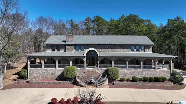 view of front of property featuring stairs and a chimney