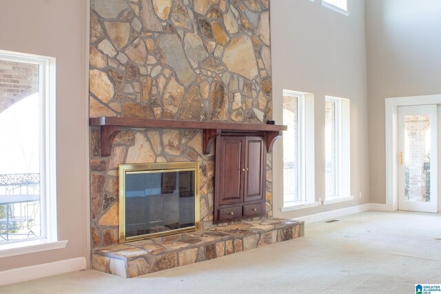 details featuring visible vents, a fireplace, baseboards, and carpet flooring