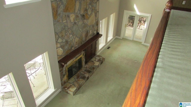 carpeted living room with a fireplace and visible vents