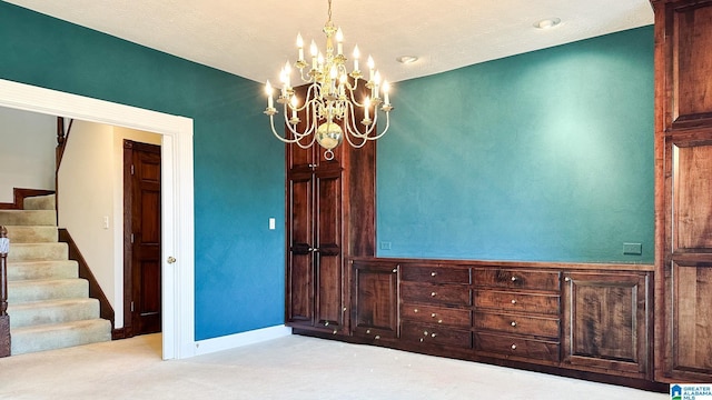 interior space featuring stairs, baseboards, a chandelier, and light colored carpet