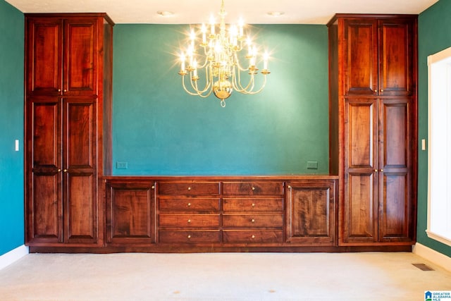 unfurnished dining area with baseboards, visible vents, and a notable chandelier