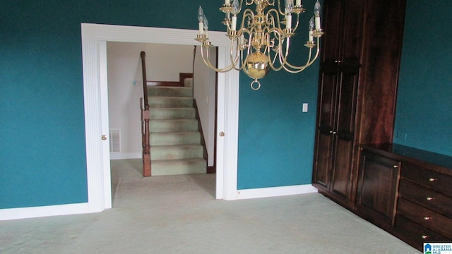 unfurnished dining area featuring light carpet, stairs, visible vents, and baseboards