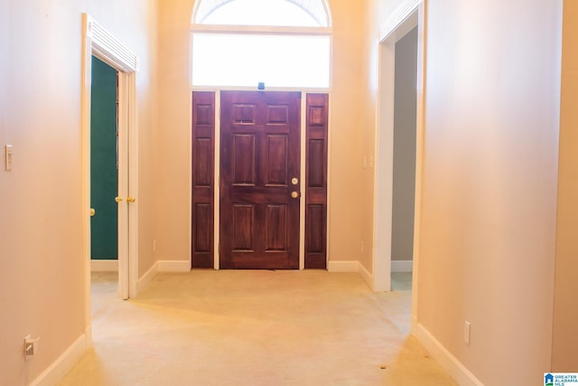 corridor with light carpet and baseboards