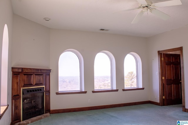 unfurnished living room with light carpet, a fireplace, and baseboards