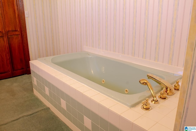 bathroom featuring tiled tub and wallpapered walls