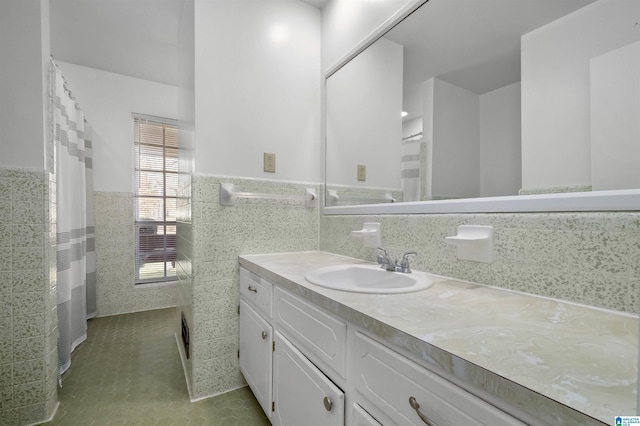 bathroom with wainscoting, vanity, and tile walls