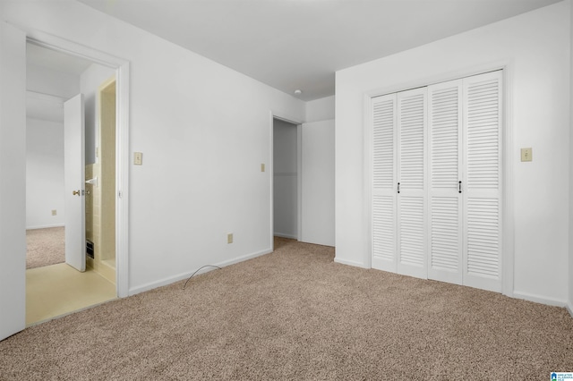 unfurnished bedroom featuring a closet and carpet flooring