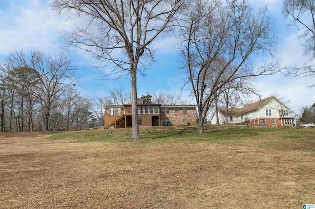 view of yard featuring a deck and stairs