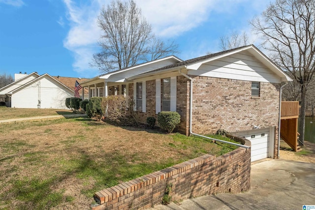 ranch-style home featuring a garage, a front yard, concrete driveway, and brick siding