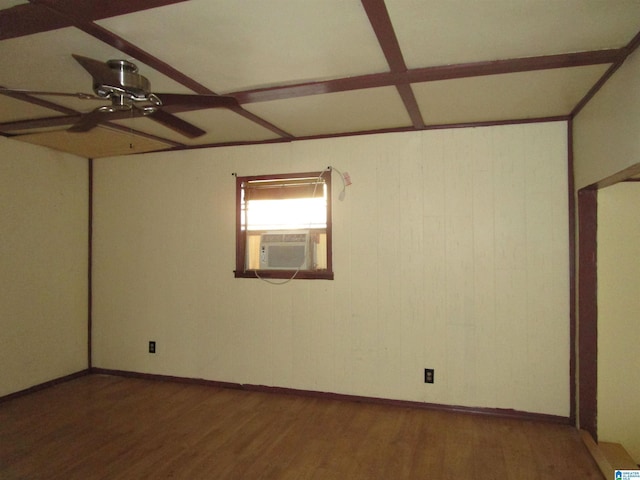 spare room with dark wood-style floors, cooling unit, a ceiling fan, and baseboards