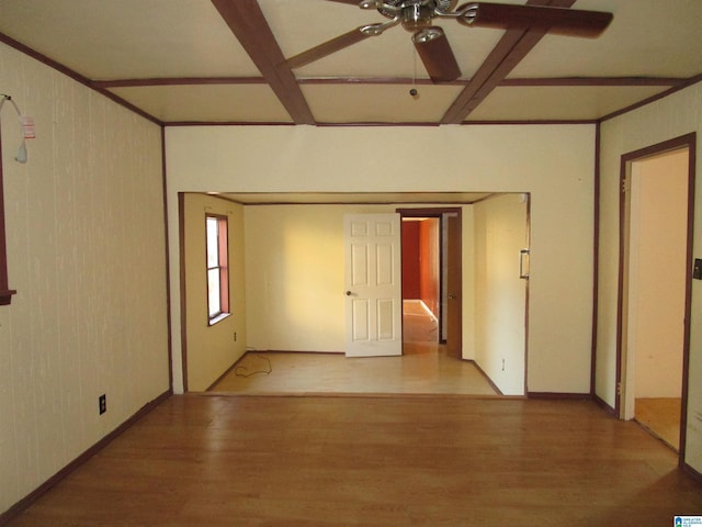 unfurnished room featuring ceiling fan, coffered ceiling, beamed ceiling, and wood finished floors