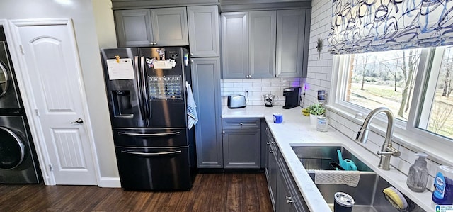 kitchen with refrigerator with ice dispenser, gray cabinets, and a sink