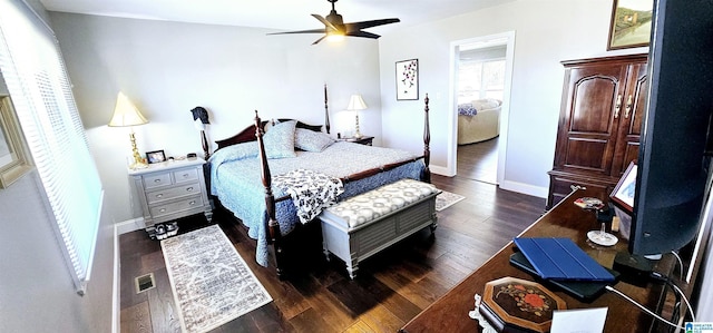 bedroom featuring a ceiling fan, dark wood-style flooring, visible vents, and baseboards