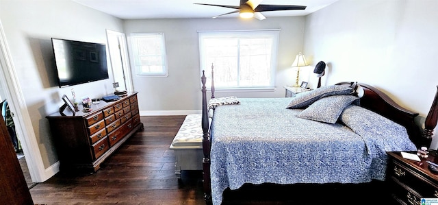 bedroom featuring dark wood-style floors, a ceiling fan, and baseboards