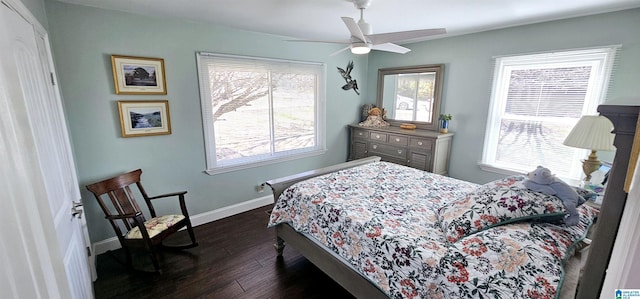 bedroom featuring a ceiling fan, dark wood finished floors, and baseboards