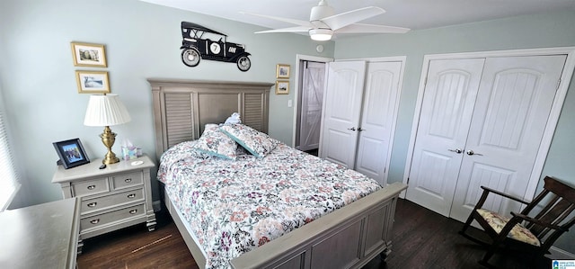 bedroom featuring a ceiling fan, dark wood finished floors, and multiple closets