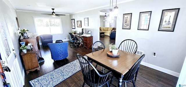 dining space with ornamental molding, dark wood finished floors, and baseboards