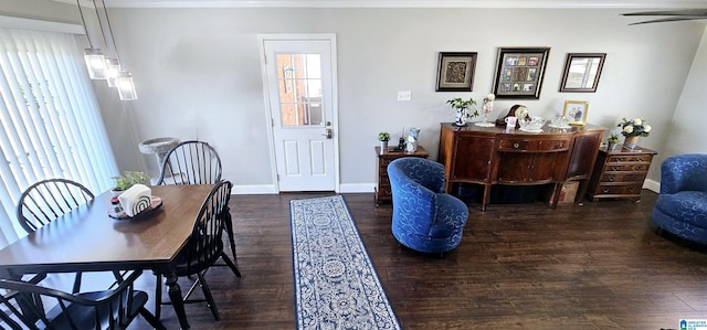 dining area featuring dark wood finished floors and baseboards