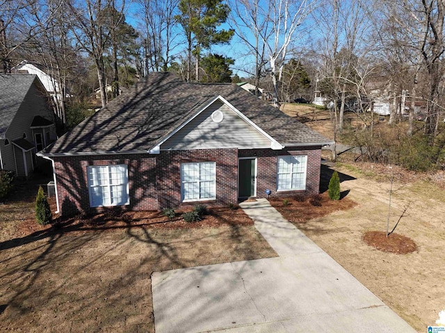 ranch-style house with brick siding and roof with shingles