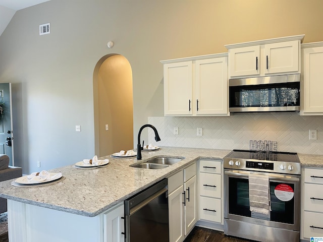 kitchen with white cabinets, visible vents, stainless steel appliances, and a sink