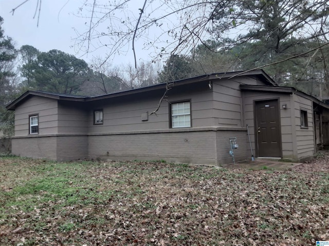 view of property exterior with brick siding