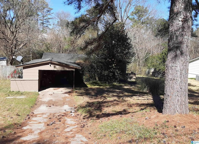 view of yard featuring an outdoor structure and fence