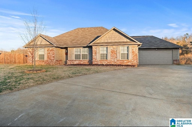 view of front of house with a garage, brick siding, fence, concrete driveway, and a front lawn