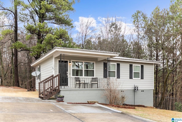 view of front of home featuring metal roof and crawl space