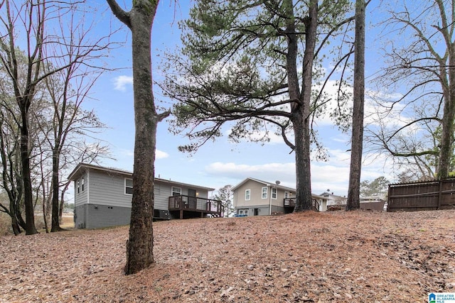 view of yard featuring fence and a deck