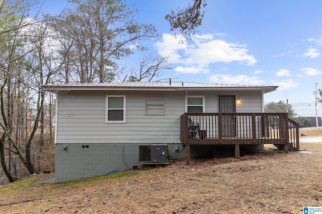 rear view of house featuring crawl space, metal roof, a wooden deck, and central air condition unit