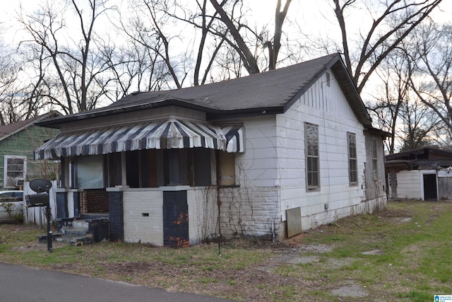 view of property exterior with crawl space and a shingled roof