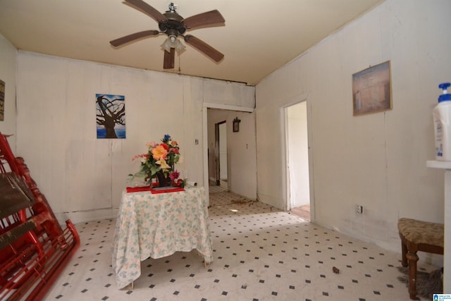 interior space with ceiling fan