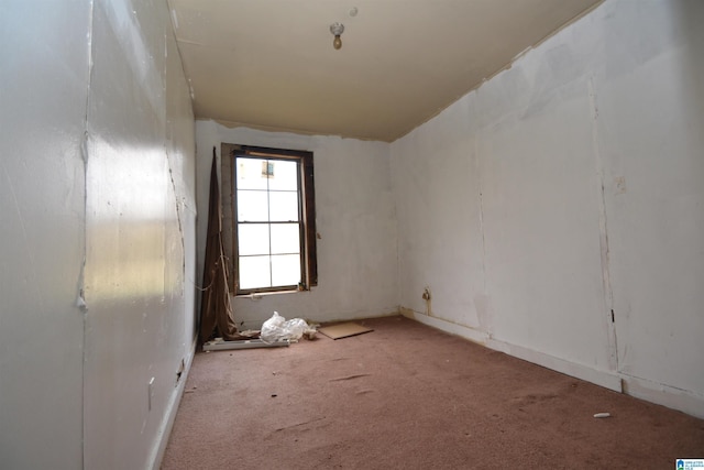 unfurnished room featuring light carpet