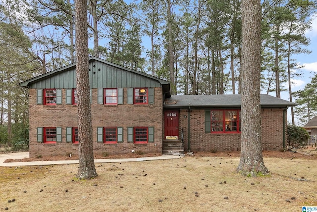 tri-level home with board and batten siding and brick siding