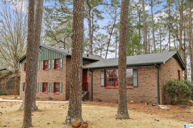 split level home with board and batten siding and brick siding